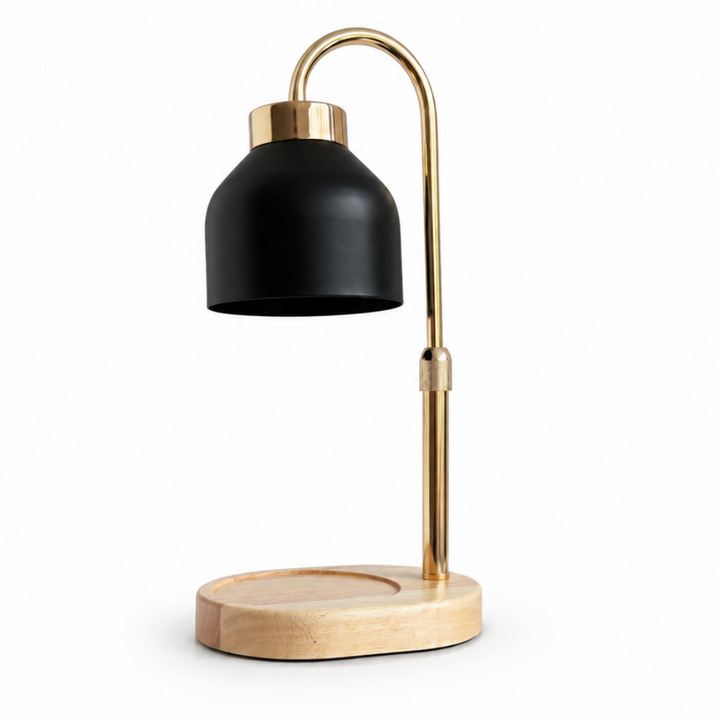 A candle warming lamp with a matte black dome-shaped shade, a curved gold metal stem, and a light natural wood base, shown on a plain white background.