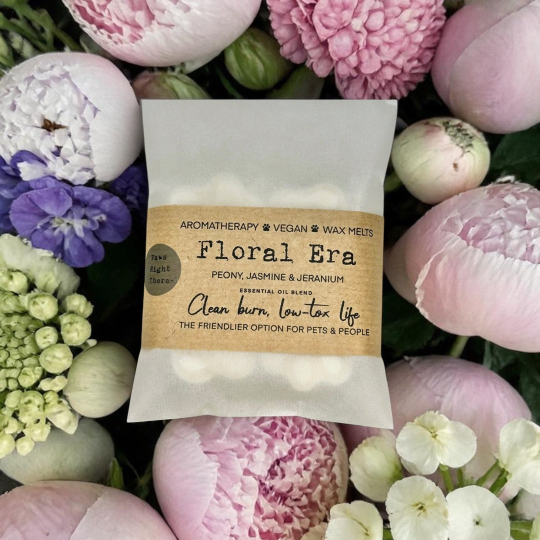 Floral wax melts packaging surrounded by pink flowers
