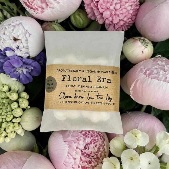 Floral wax melts packaging surrounded by pink flowers